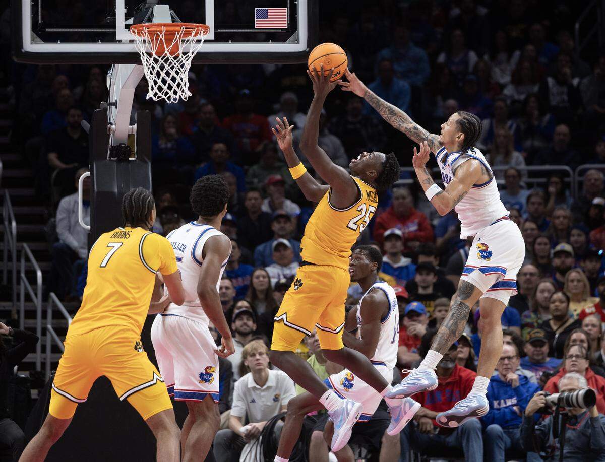 Kansas’ Tre White blocks the shot of Missouri’s Mark Mitchell during the second half of their game at T-Mobile Center on Sunday, Dec. 7, 2025.