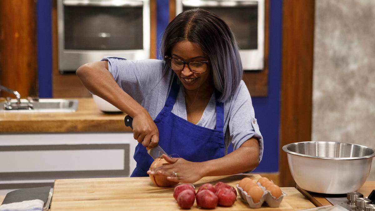 Blue team recruit Chandali Gullick cooks during the skill drill challenge, as seen on Worst Cooks in America, Season 21.