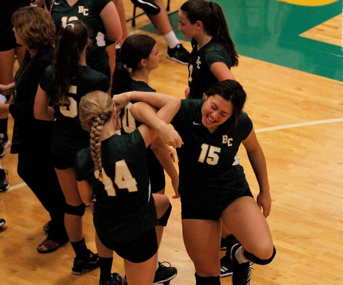 Carroll sophomore outside hitter Ella Larkin (left) and senior middle hitter Britney Ho (right) get hyped before the Golden Eagles’ triangular with Kapaun Mt. Carmel and Wichita East on Tuesday. (Sept. 4, 2018)
