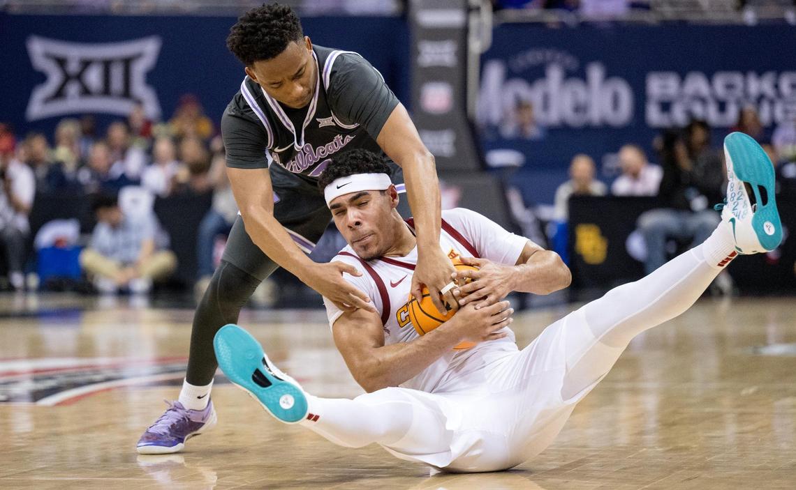 Kansas State Wildcats guard Tylor Perry (2) fights for the ball with Iowa State Cyclones guard Tamin Lipsey (3) during an NCAA basketball game in the Big 12 men’s basketball tournament on Thursday, March 14, 2024, in Kansas City.