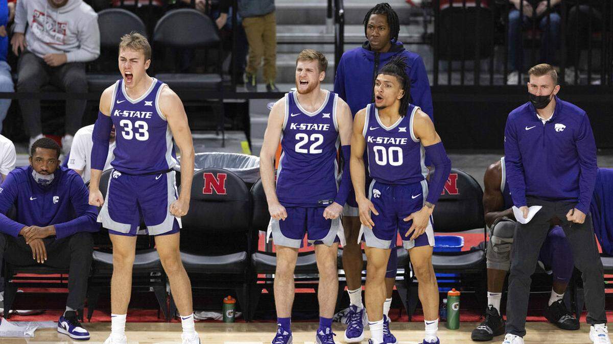 From left, Kansas State’s Logan Landers (33), Luke Kasubke (22) and Mike McGuirl (00) react from the bench after a teammate’s basket against Nebraska during the second half of an NCAA college basketball game Sunday, Dec. 19, 2021, in Lincoln, Neb. (AP Photo/Rebecca S. Gratz)