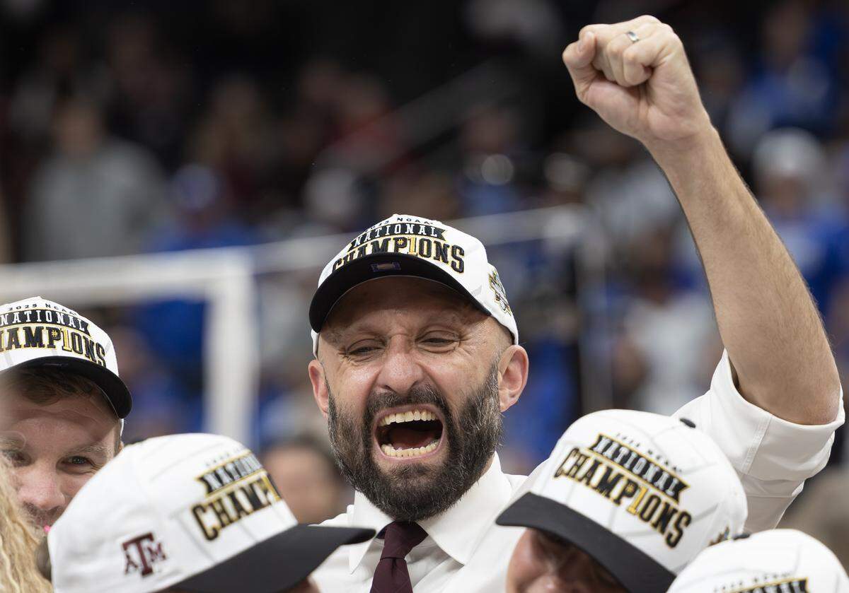 Texas A&M coach Jamie Morrison celebrates his team’s victory over Kentucky at the NCAA Women’s Volleyball Championship on Sunday afternoon at the T-Mobile Center.