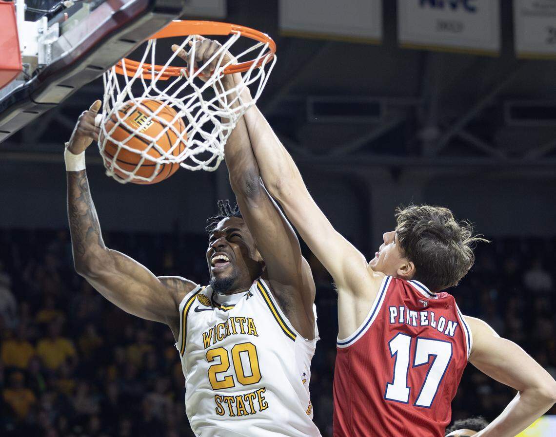 Wichita State’s Emmanuel Okorafor get the dunk a foul against Florida Atlantic’s Xander Pintelon during the first half on Saturday at Koch Arena.