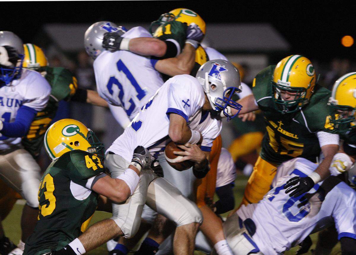 Kapaun QB Keaton Lewis is stopped by Bishop Carroll’s Beau Bell (43) as he attempts a two-point conversion towards the end of the game The stop helped Carroll win 36-34 Friday night.