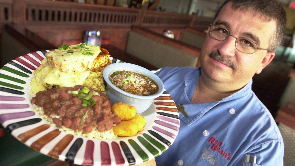 Rick Jeffrey, who created many of Wichita’s once-favorite recipes as a chef and owner at Red Bean’s Bayou Grill, is pictured in 2002 with one of his locally-famous Cajun dishes: pork loin Thibideaux.