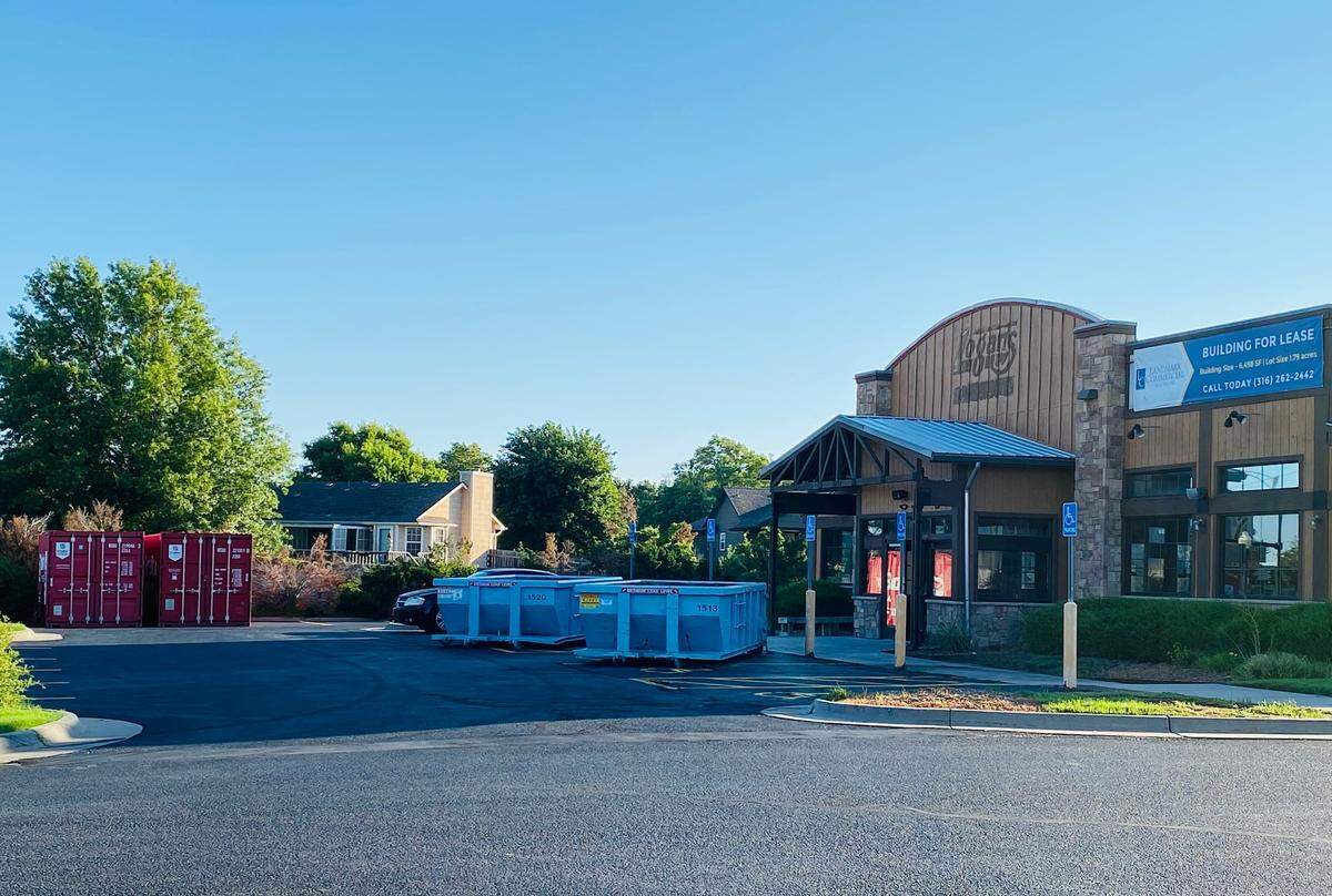 Dumpsters outside the old Logan’s Roadhouse building, which by early next year will be home to a new restaurant called Sickies Garage Burgers & Brew.