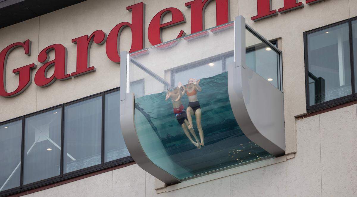 Young swimmers float over Douglas in the eye-catching rooftop pool at the Hilton Garden Inn. The pool has been open about a week inside the 3 1/2-year-old hotel.