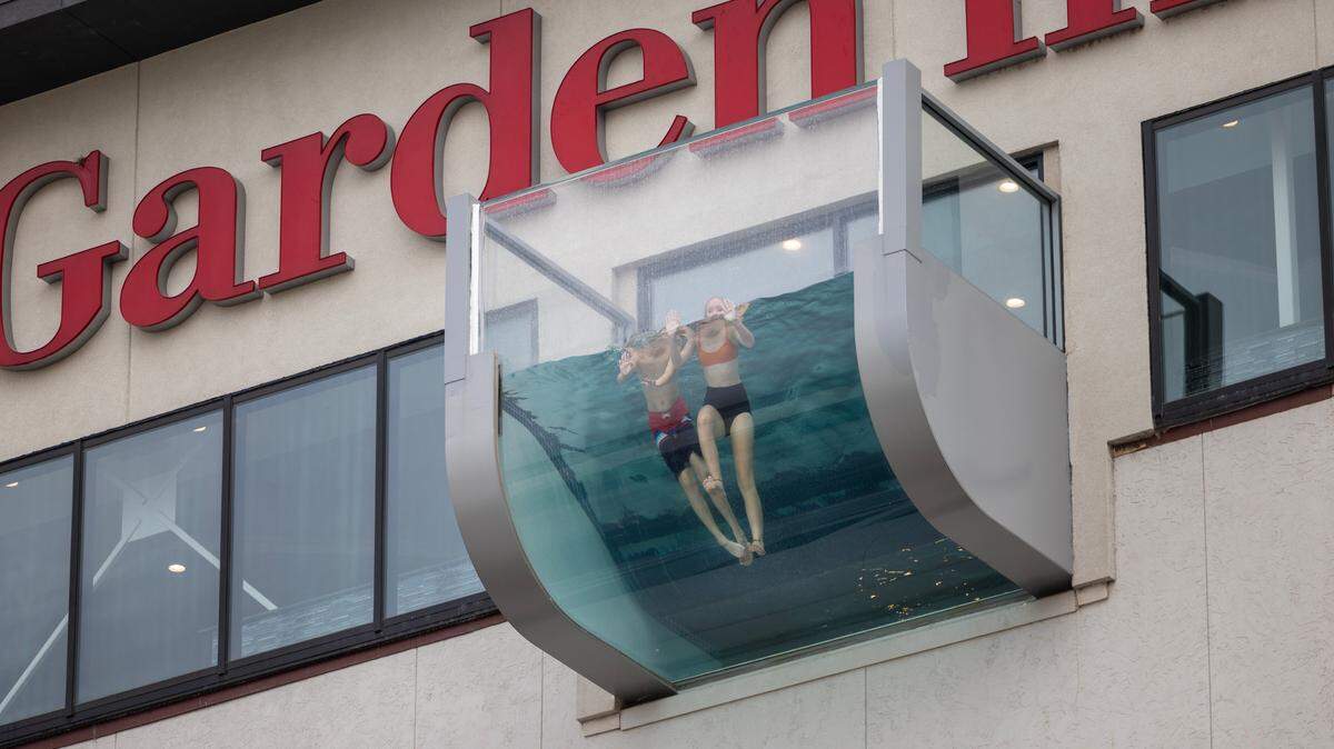 Young swimmers float over Douglas in the eye-catching rooftop pool at the Hilton Garden Inn. The pool has been open about a week inside the 3 1/2-year-old hotel.