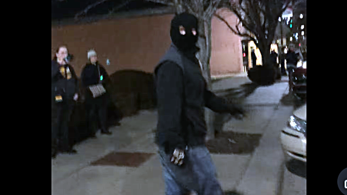 A Nazi in a homemade ski mask confronts Christian worshipers, who gathered outside the Wichita office of the Department of Homeland Security Sunday evening for a prayer service protesting Trump administration immigration policies and lamenting the killing of a Minnesota woman by an angry ICE agent.