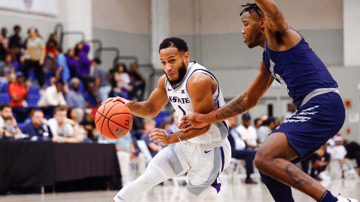 Kansas State point guard Markquis Nowell dribbles past a Nevada defender at the Cayman Islands Classic.