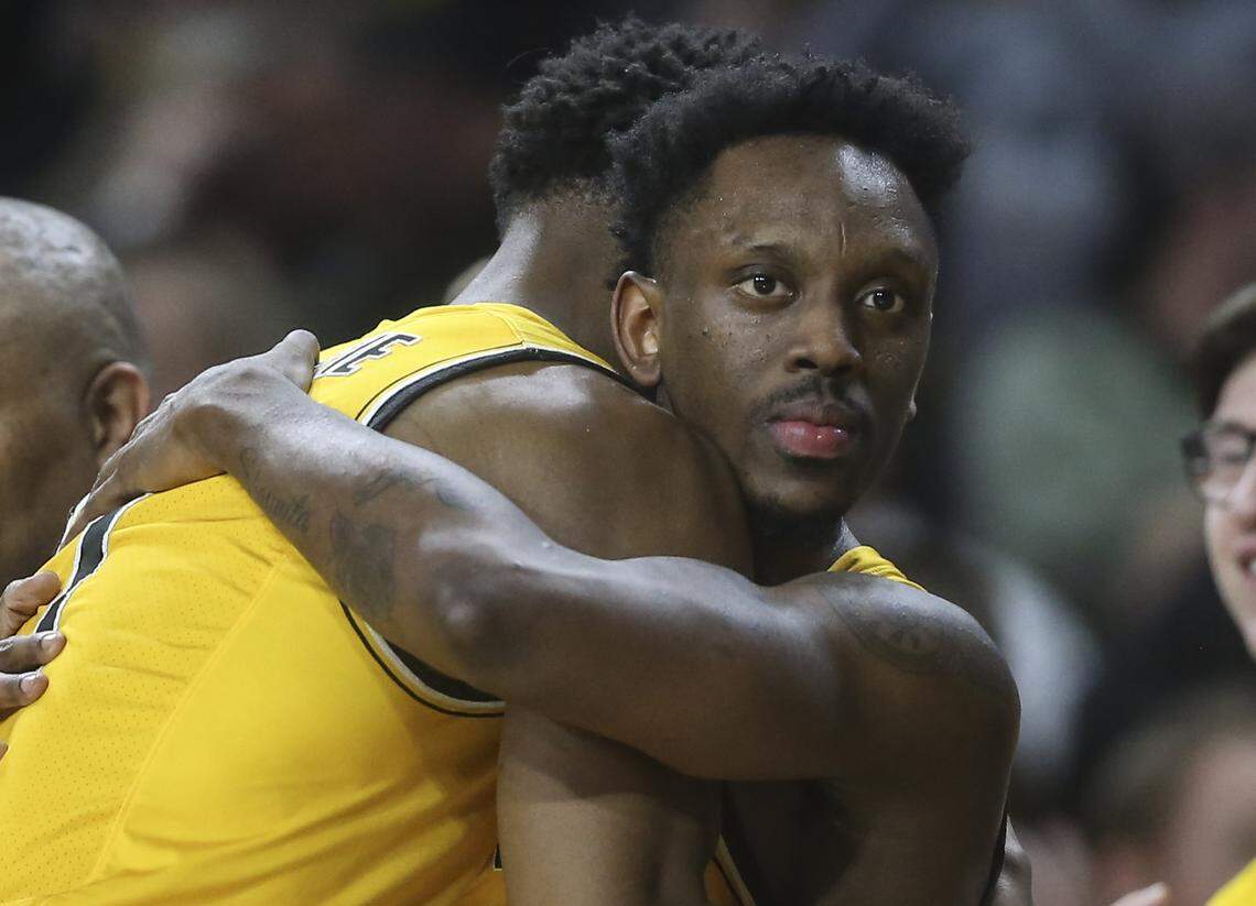 Wichita State guard Samajae Haynes-Jones hugs senior teammate Markis McDuffie after they checked out of the game against East Carolina on Tuesday.