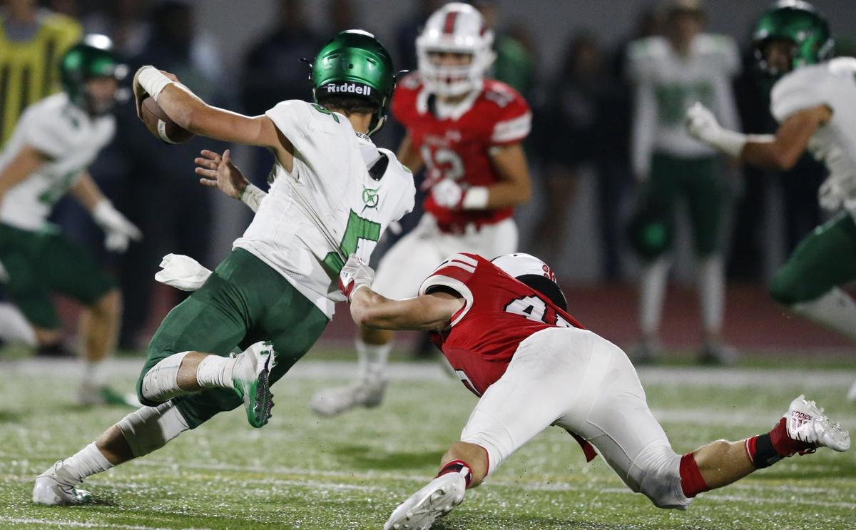 Maize linebacker #45 Kendall Norrod grabs the shirt tail of Derby quarterback #5 Hunter Igo.(October 19, 2018)