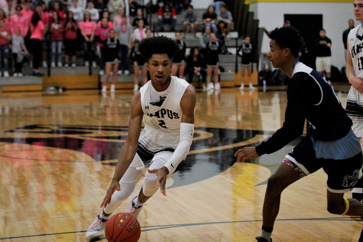 Campus junior Shawn Warrior drives to the basket on Wichita East’s Amos Alford Jr. during the Colts’ 75-47 win Saturday over the Aces on Saturday in the AVCTL/GWAL Challenge. (Jan. 12, 2019)