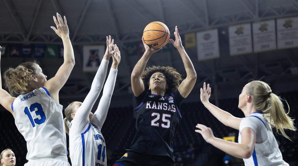 Kansas women’s basketball standout Jaliya Davis cuts through a trio of BYU defenders during the first half of their WBIT semifinal game at Wichita’s Koch Arena on Monday, March 30, 2026.