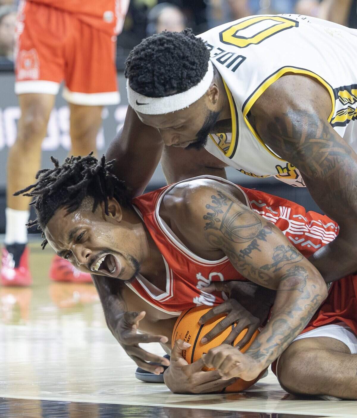 Morris Udeze fights for a loose ball with Jemel Jones of The Enchantment during the first half of their second game of the TBT tournament at Koch Arena on Thursday night.
