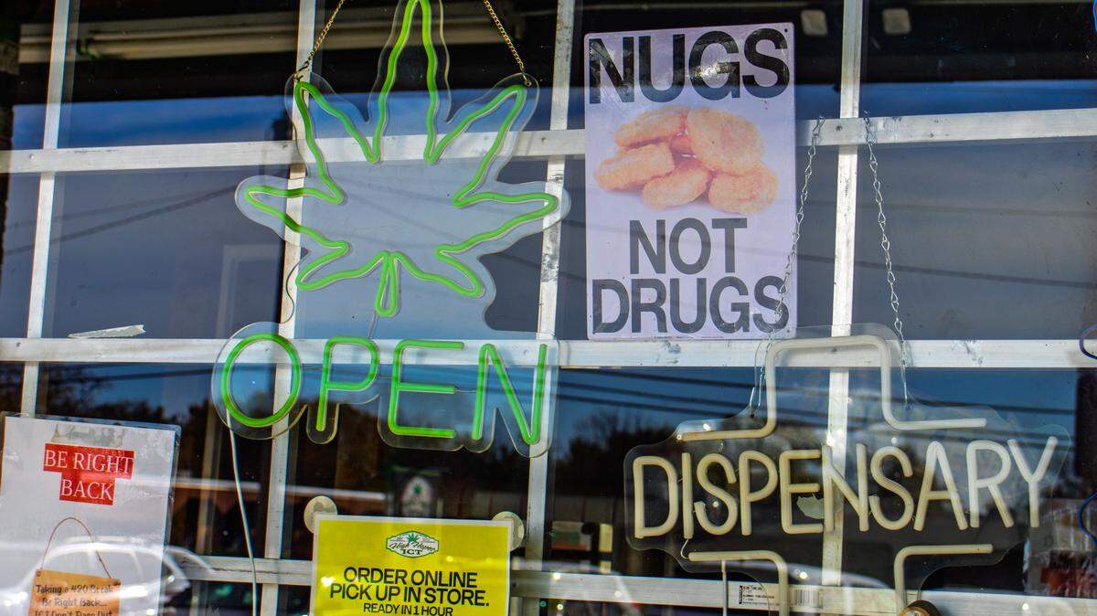 The window of the High Hopes ICT storefront at 3108 W. 13th St. sits dark after the business's owner and an associate were arrested Thursday morning.