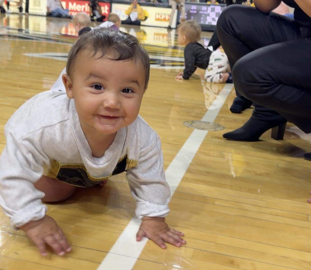 Moses Hurst, 8 months, may have won the Wichita State Shockers’ baby race last week, but here he’s shown eagerly crawling off the racetrack toward videographer Jaime Green.