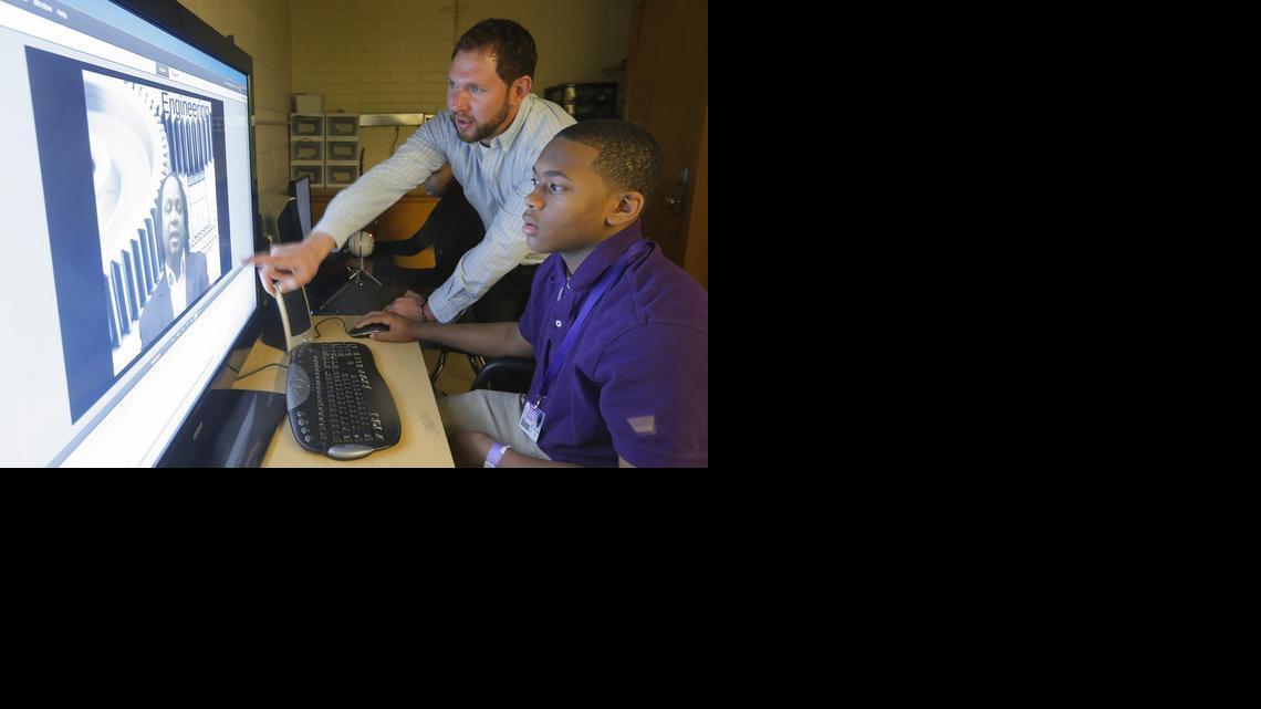Teacher Clint Dayhuff works with seventh-grader Clearance Reed in a video production class at Brooks Middle School. The class is part of the school’s STEM (Science, Technology, Engineering and Math) curriculum. (Feb. 13, 2014)

