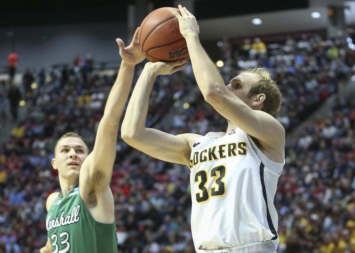Wichita State guard Conner Frankamp hits a three against Marshall guard Jon Elmore during the NCAA Tournament in San Diego.