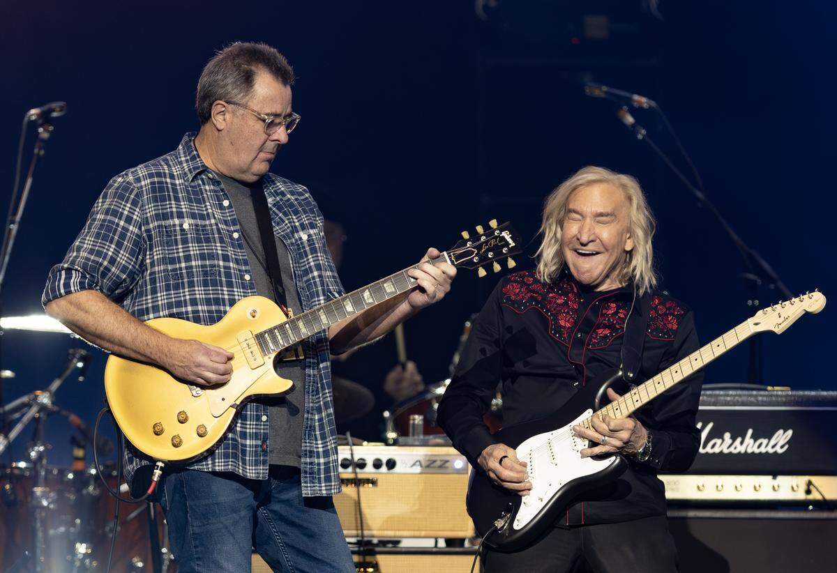 Joe Walsh, right, plays the James Gang classic “Funk 49” with 22-time Grammy winner Vince Gill at Intrust Bank Arena on Saturday night. Gill was one of several musicians on hand for Walsh’s VetsAid concert.