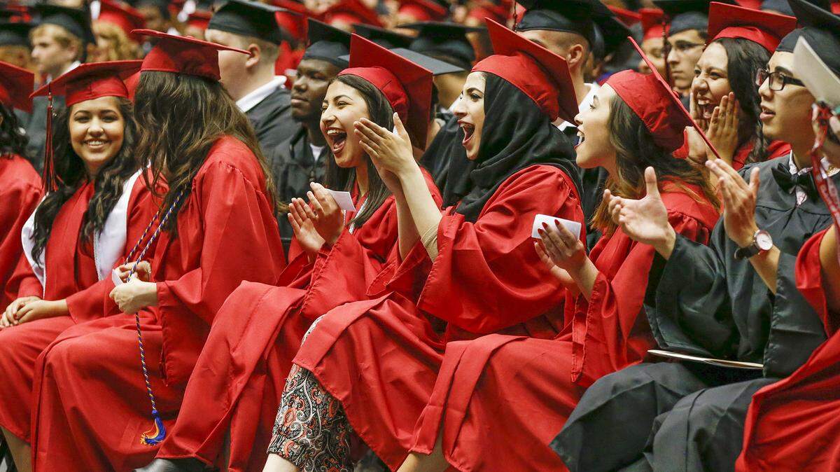 Members of the Heights High School graduating class of 2015 applaud during their ceremony at Koch Arena.