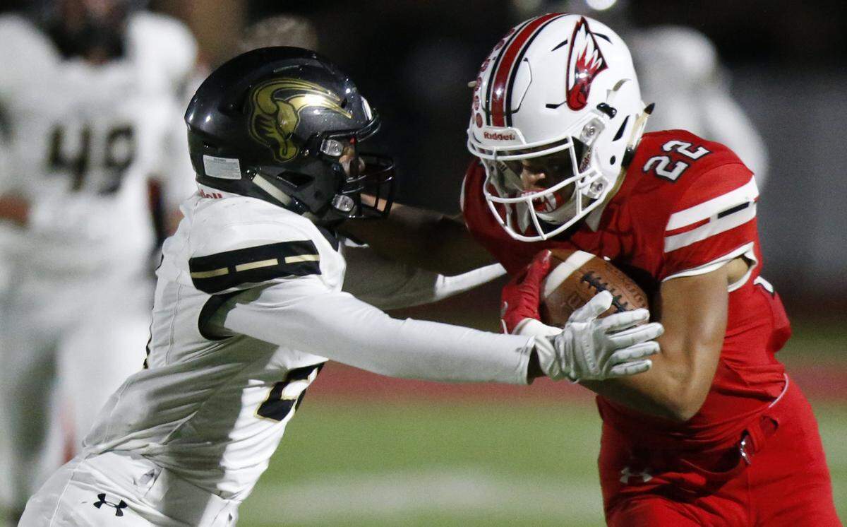 Maize wide receiver #22 Preven Christon pushes away Maize South defender #21 Trevion Mitchell on a long pass play. (November 2, 2018)
