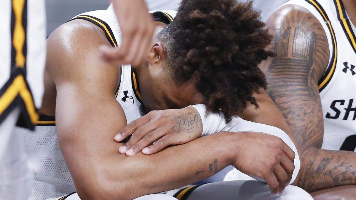 Wichita State’s Tyson Etienne hangs his head on the bench during the second half of their first round game against Tulsa at the American Athletic Conference Tournament in Fort Worth on Thursday.