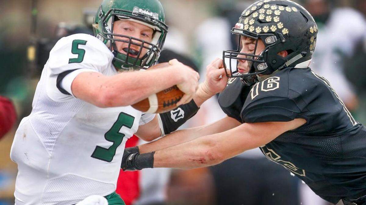 Derby’s Brady Rust is pushed out of bounds by Blue Valley's Jacob Watkins during the Class 6A championship game. Rust is the All-Class 6A quarterback. 

