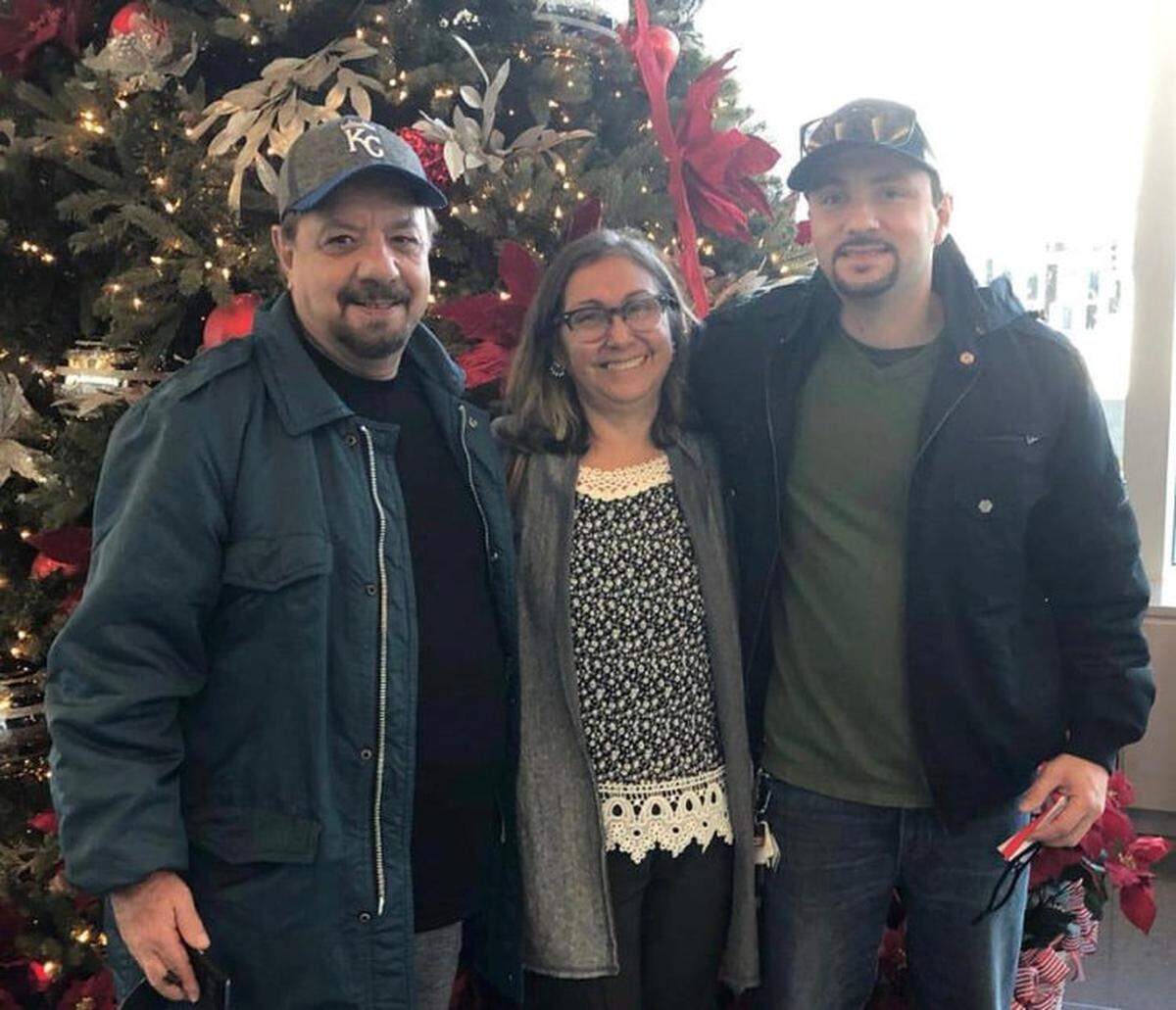 Israel Machado, right, poses with his father, Marcelo Machado, and mother, Rosane Machado, last Christmas. Israel’s mother was killed and his father injured in a stabbing Saturday in Wichita.