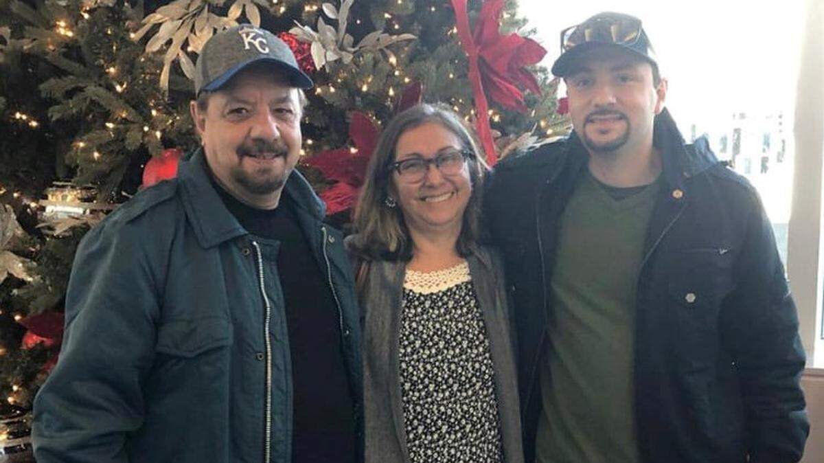 Israel Machado, right, poses with his father, Marcelo Machado, and mother, Rosane Machado, the Christmas before his mother was killed and his father injured in a home-invasion stabbing in Wichita.