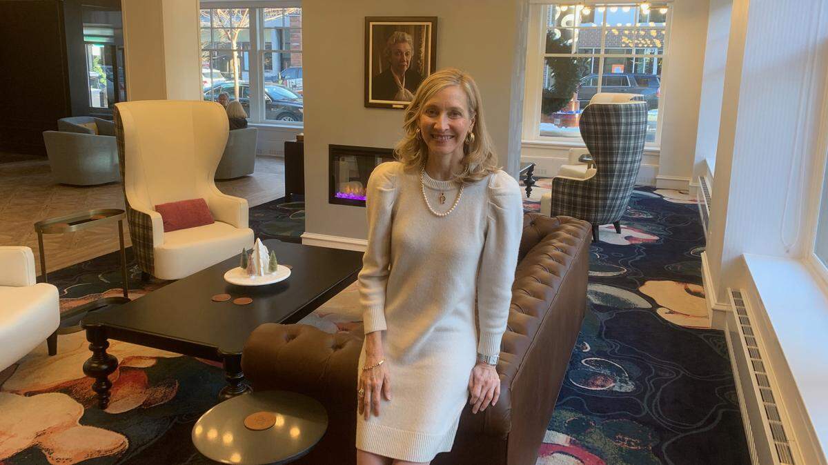 Jennifer Pitt pictured in front of her late grandmother Olive Ann Beech’s portrait at the new Olive Ann Hotel in Grand Forks, N.D.