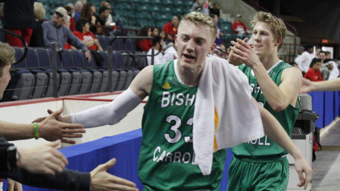 Bishop Carroll's Luke Evans (left) and Gunner Lynch celebrate after the Eagles' 58-47 victory against Mill Valley in the Class 5A boys basketball state semifinal Friday March 9, 2018, at the Kansas Expocentre in Topeka.