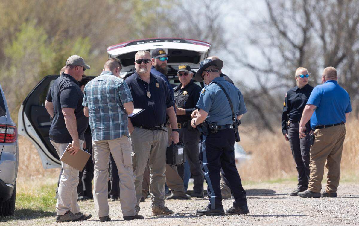 Law enforcement officers from several agencies investigate the scene where three Cowley County sheriff’s deputies were were shot and wounded on Friday north of Winfield. According to the Cowley County Sheriff’s Office, the suspect in the shootings was killed at the scene.