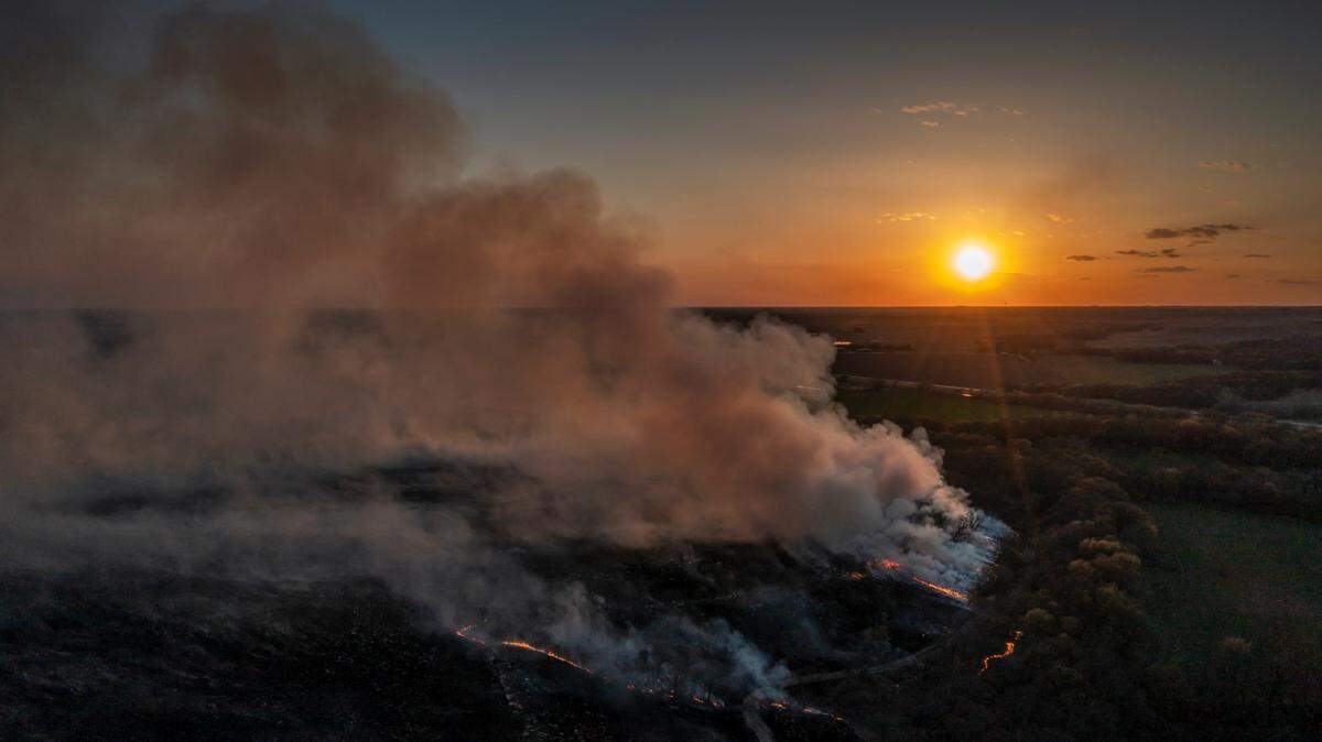 A controlled fire burns in the Kansas Flint Hills near Cedar Point. Ranchers traditionally burn the old grass off of cattle pastures in the spring to promote the growth of new grass for cattle to graze on.