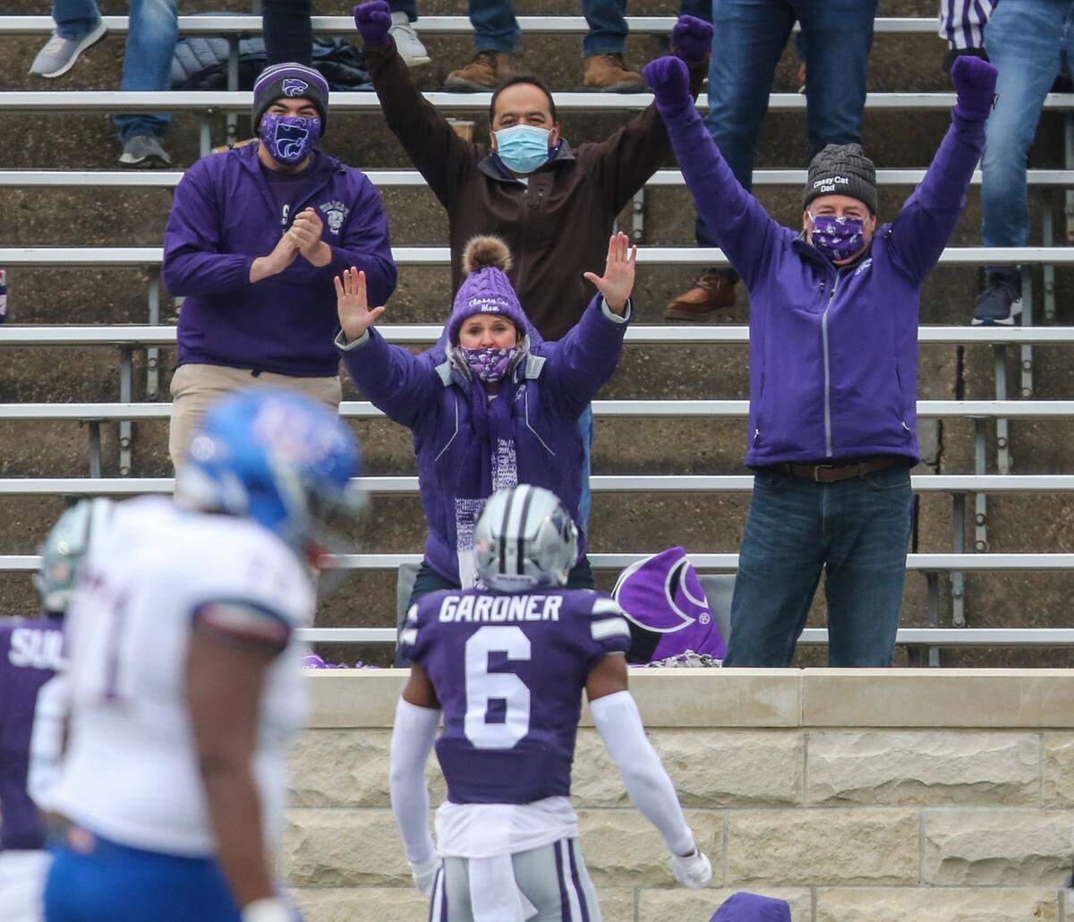 Fans celebrate as Kansas State’s Justin Gardner runs an interception back for a touchdown against Kansas on October 24, 2020. The team announced that it will not pursue a postseason invitation because of mounting COVID-19 issues on its roster.
