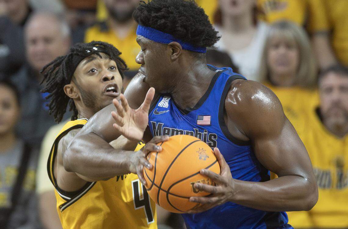 Wichita State’s Colby Rogers, left, commits a foul against Memphis’ Malcolm Dandridge during the first half on Sunday at Koch Arena.