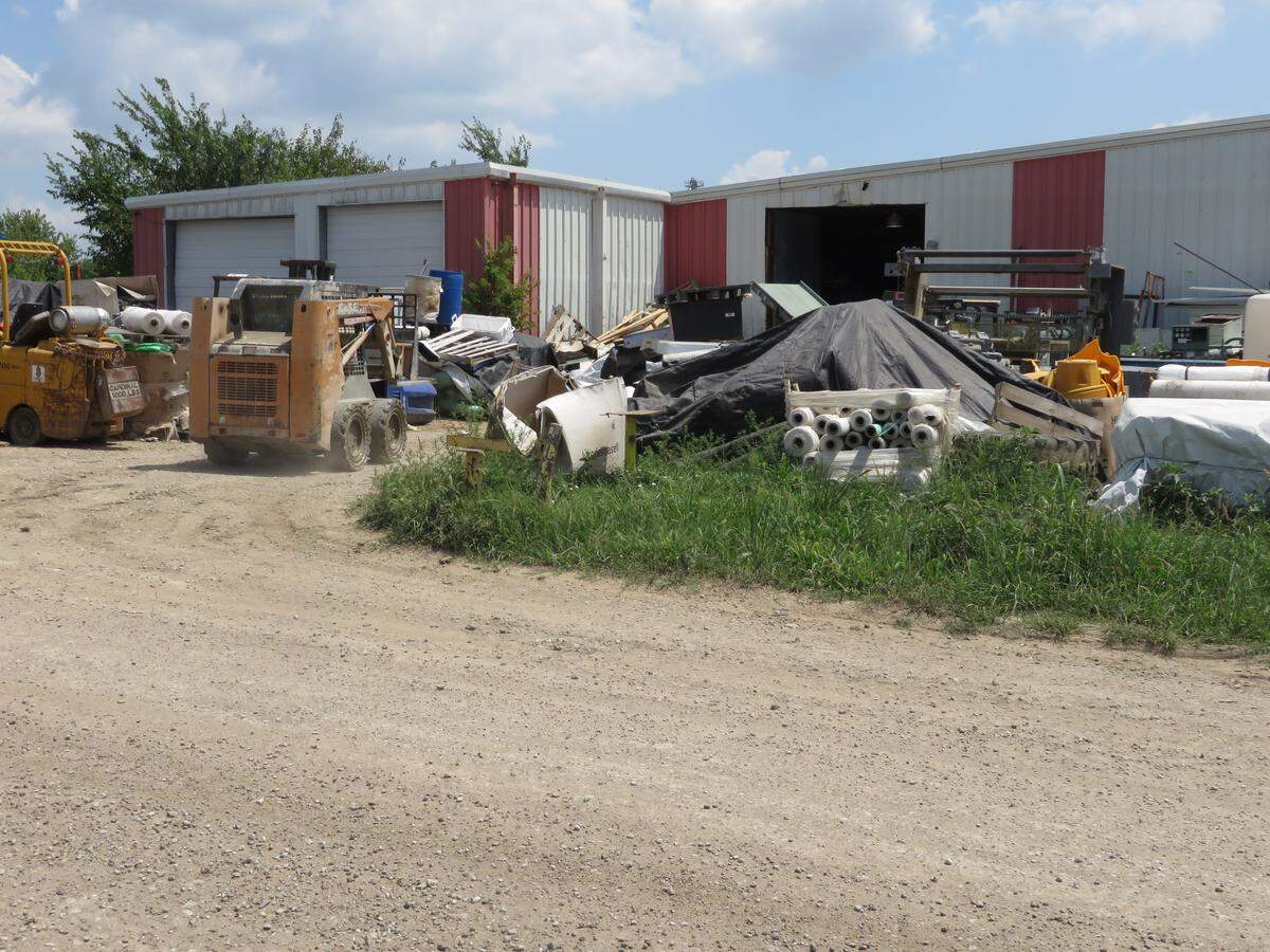 A skid loader moves stuff around at the IPS site.