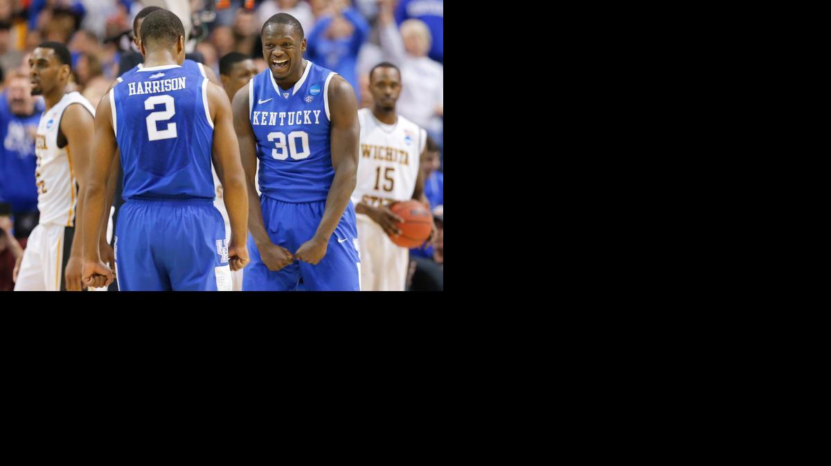 Kentucky players Aaron Harrison and Julius Randle celebrate in the third round of the NCAA Tournament. Kentucky went on to win 78-76, ending Wichita State's historic season at 35-1.

