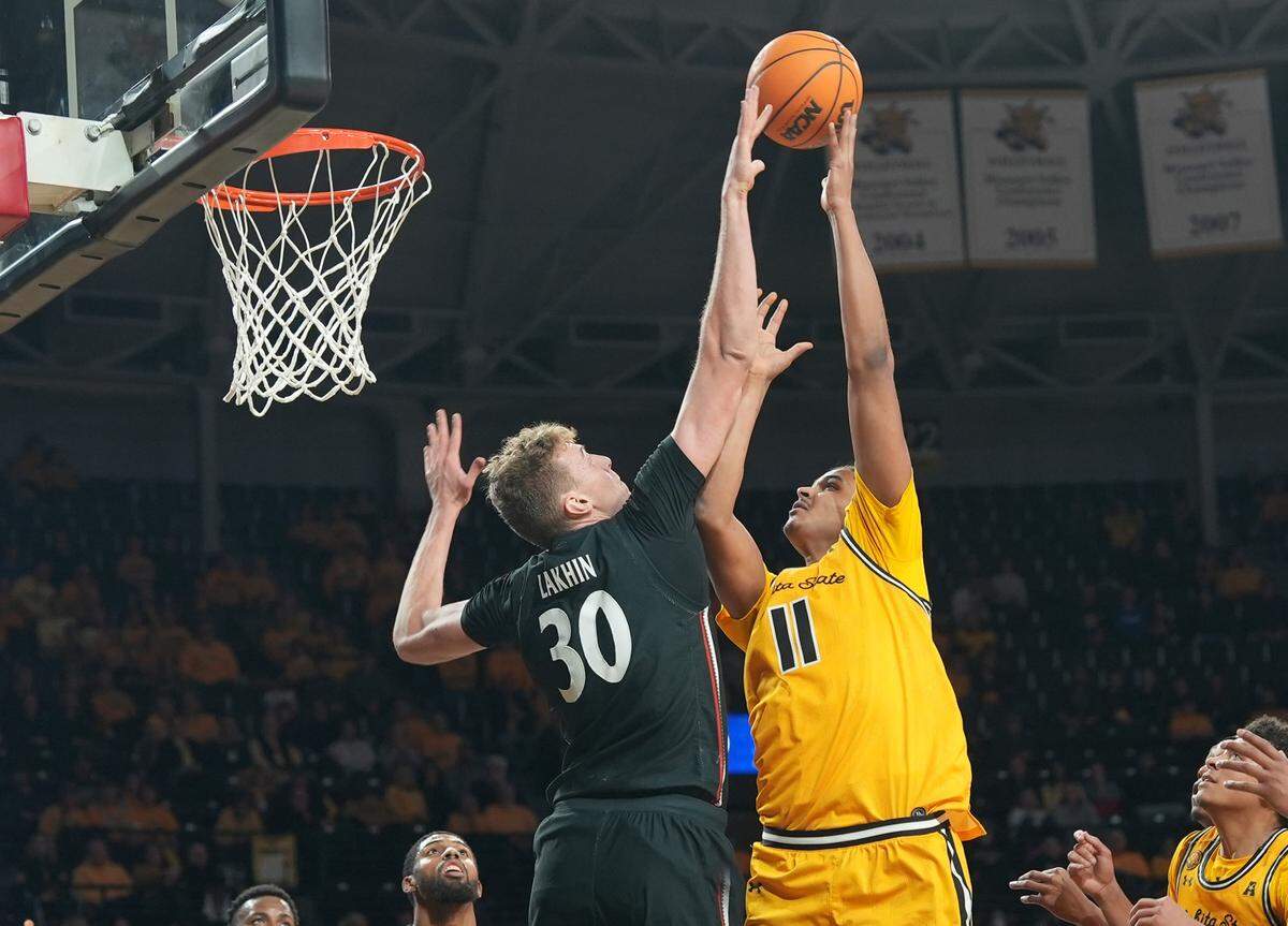 Cincinnati’s Viktor Lakhin blocks Wichita State’s Kenny Photos’ shot during the first half of their game at Charles Koch Arena.