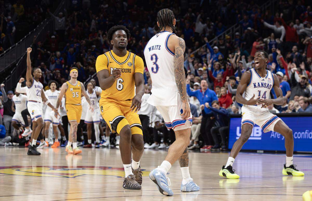 Kansas’ Tre White and teammates celebrates a three pointer at the buzzer before the half against Missouri on Sunday at the T-Mobile Center.