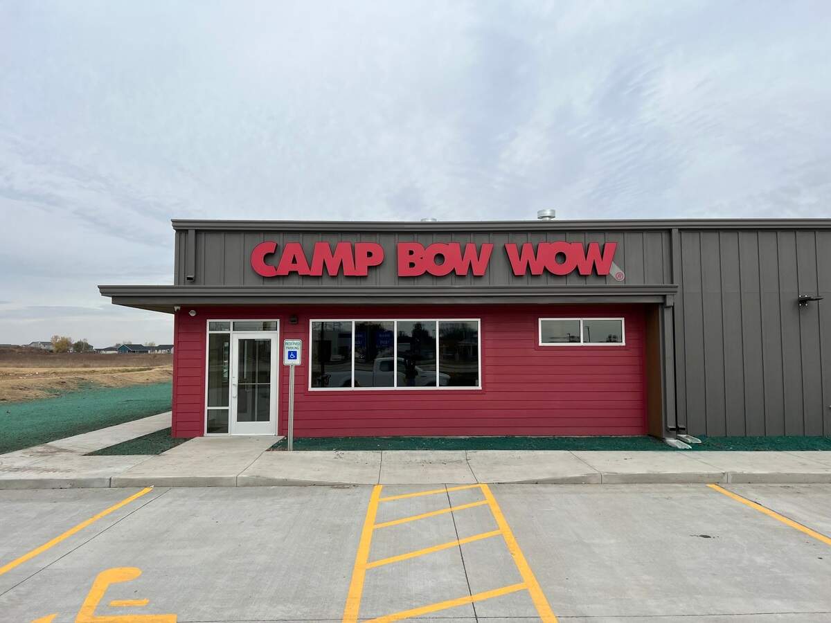Michael and Jennifer Schroeder are expanding beyond their Smoots Creek Kennels with the new Camp Bow Wow boarding business in Goddard.