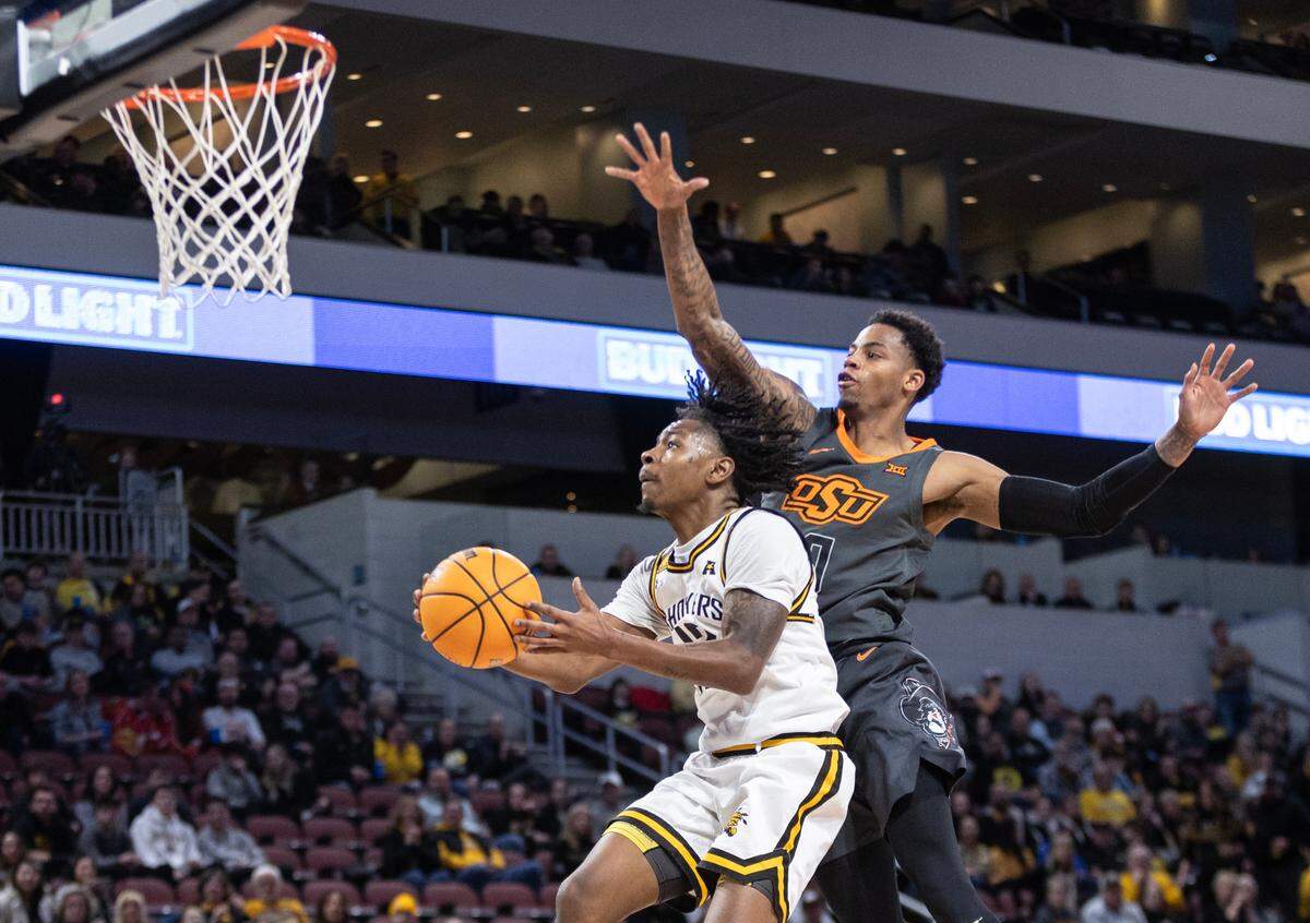 Wichita State’s Melvion Flanagan goes up for a shot against Oklahoma State’s Avery Anderson III during the first half of their game at Intrust Bank Arena on Saturday night.