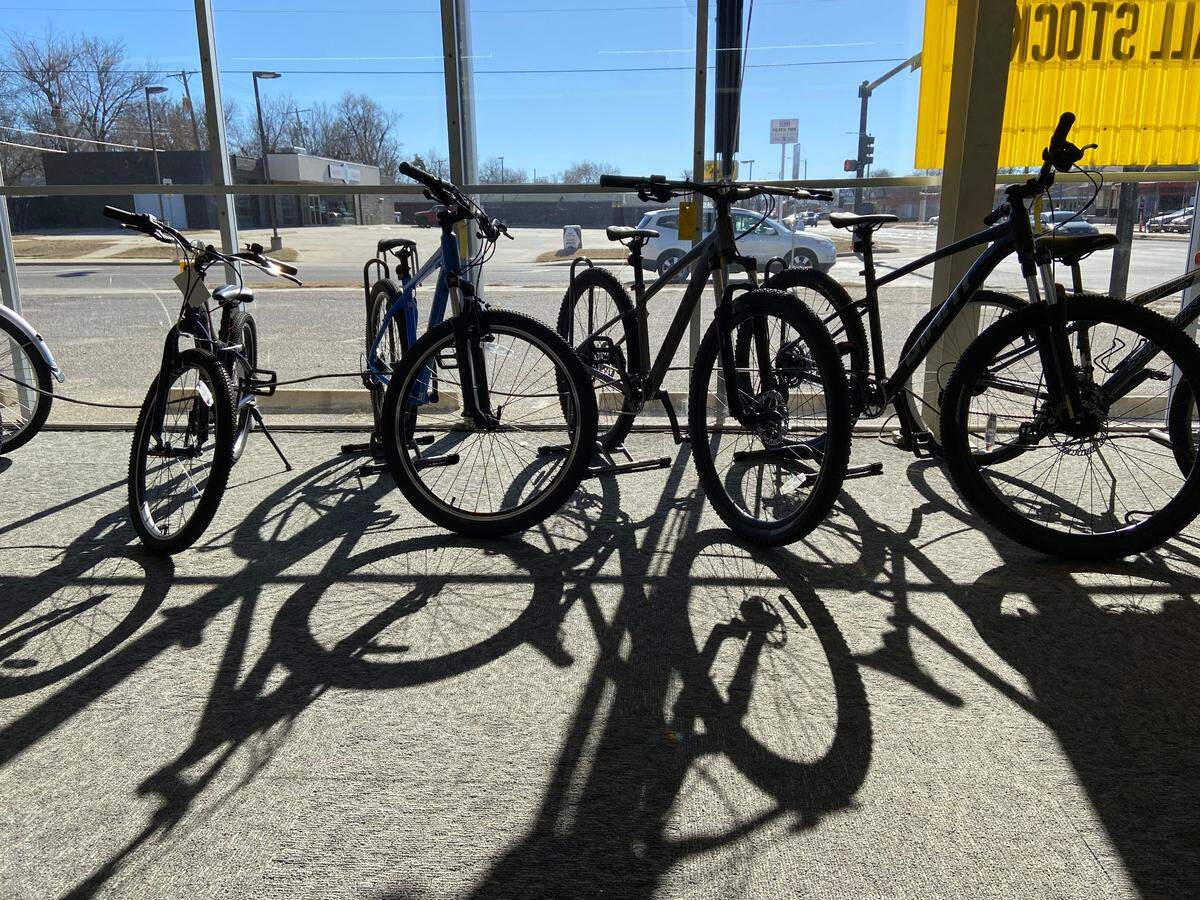 A row of bikes line up the glass wall of the longtime bicycle shop that faces Mount Vernon street in south Wichita.