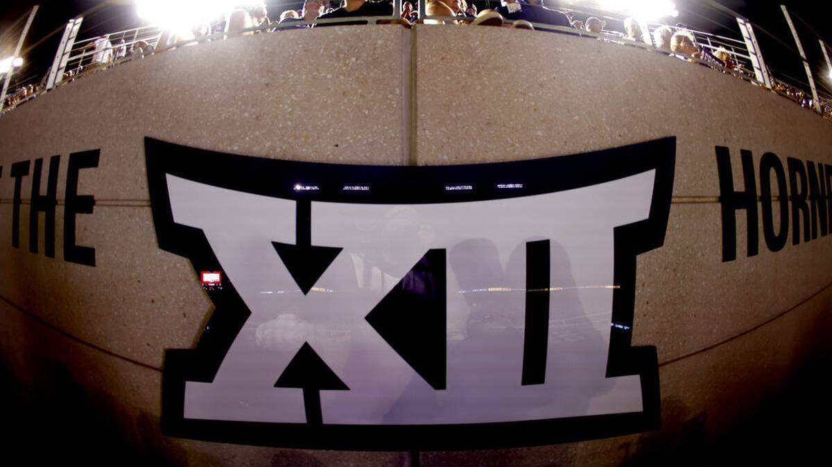 Fans watch from above a Big 12 Conference logo during the second half of an NCAA college football game on Saturday, Sept. 4, 2021, in Fort Worth, Texas.