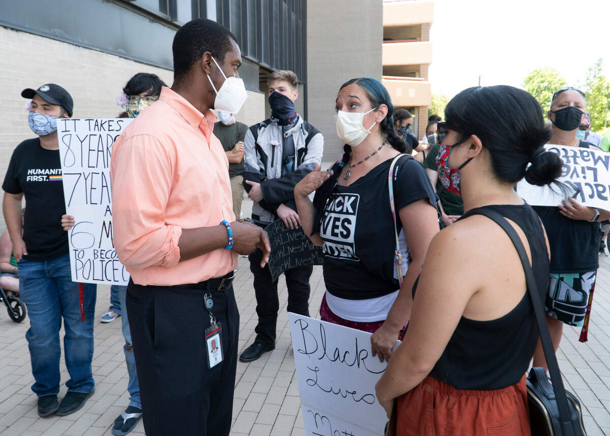 Wichita City council member Brandon Johnson talks to Melissa Tovar-Ohlson during a rally at Wichita City Hall on June 4, 2020. Johnson answered her question about body cameras on Wichita Police officers function. Council member Brandon Johnson will co-chair the mayor’s special committee to address racial and police-brutality issues raised by the protests.