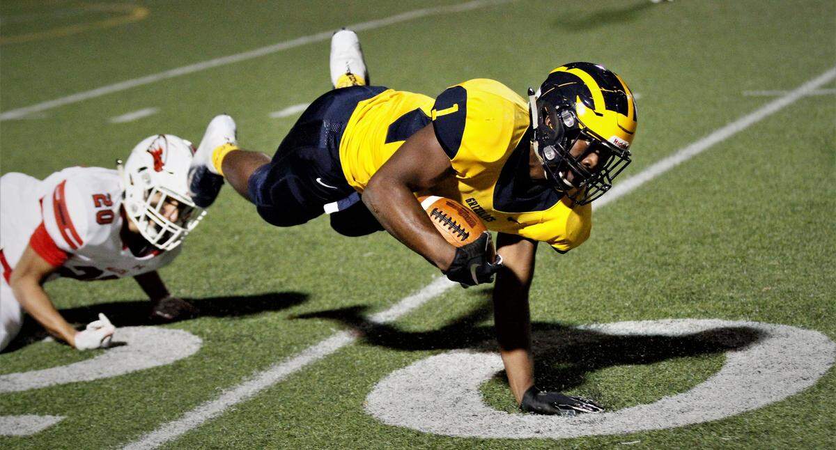 Northwest senior running back Breece Hall goes airborne during the Grizzlies’ state semifinal against Maize on Friday. (Nov. 16, 2018)