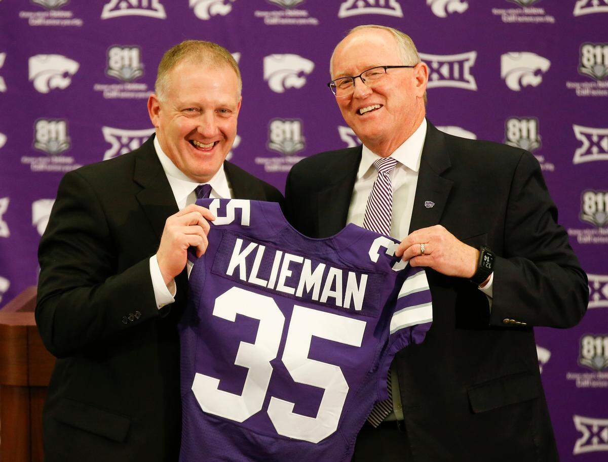 Chris Klieman (left) is introduced as the new head coach at K-State Wednesday afternoon.  Athletic Director Gene Taylor presented Klienman with a jersey marking the 35th coach at K-State . (December 11, 2018)