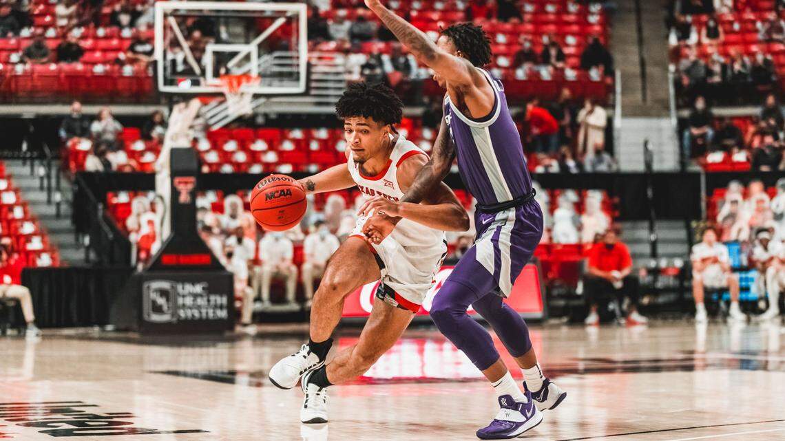 Texas Tech guard Micah Peavy drives the basketball against Kansas State guard DaJuan Gordon.