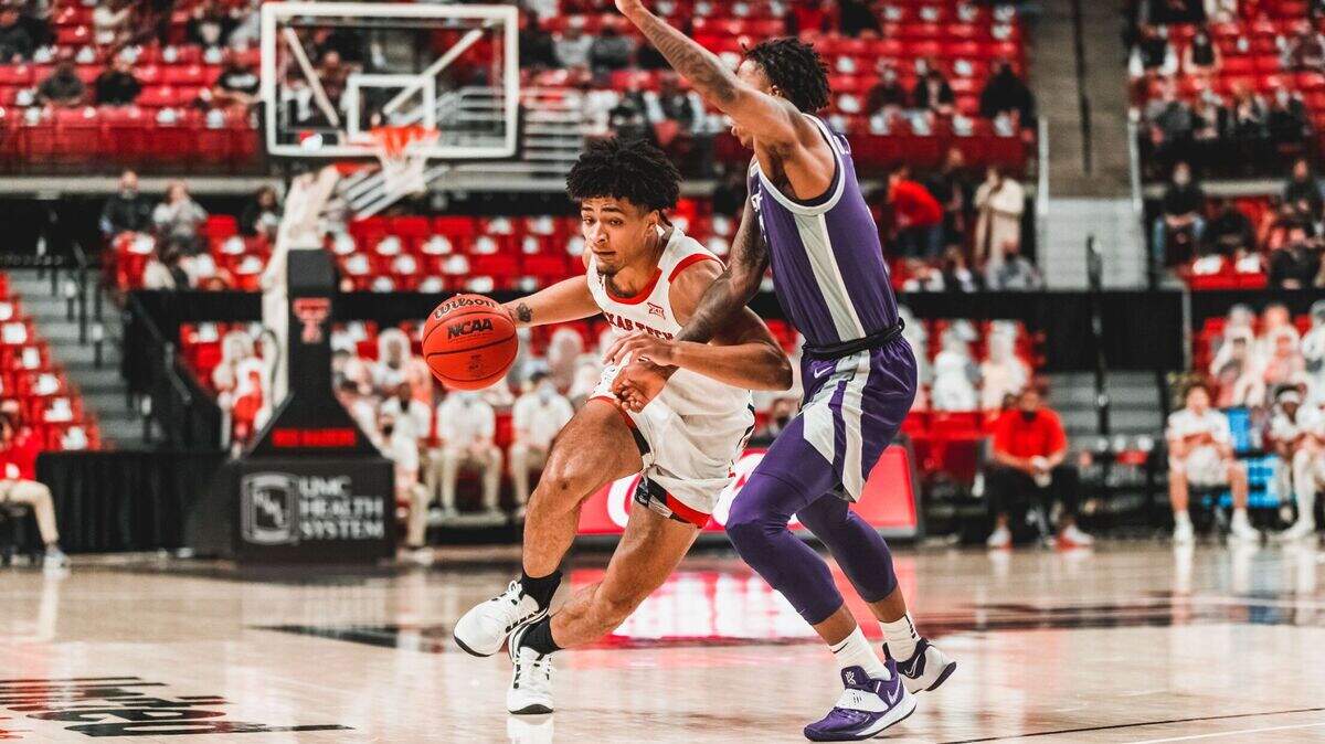 Texas Tech guard Micah Peavy drives the basketball against Kansas State guard DaJuan Gordon.