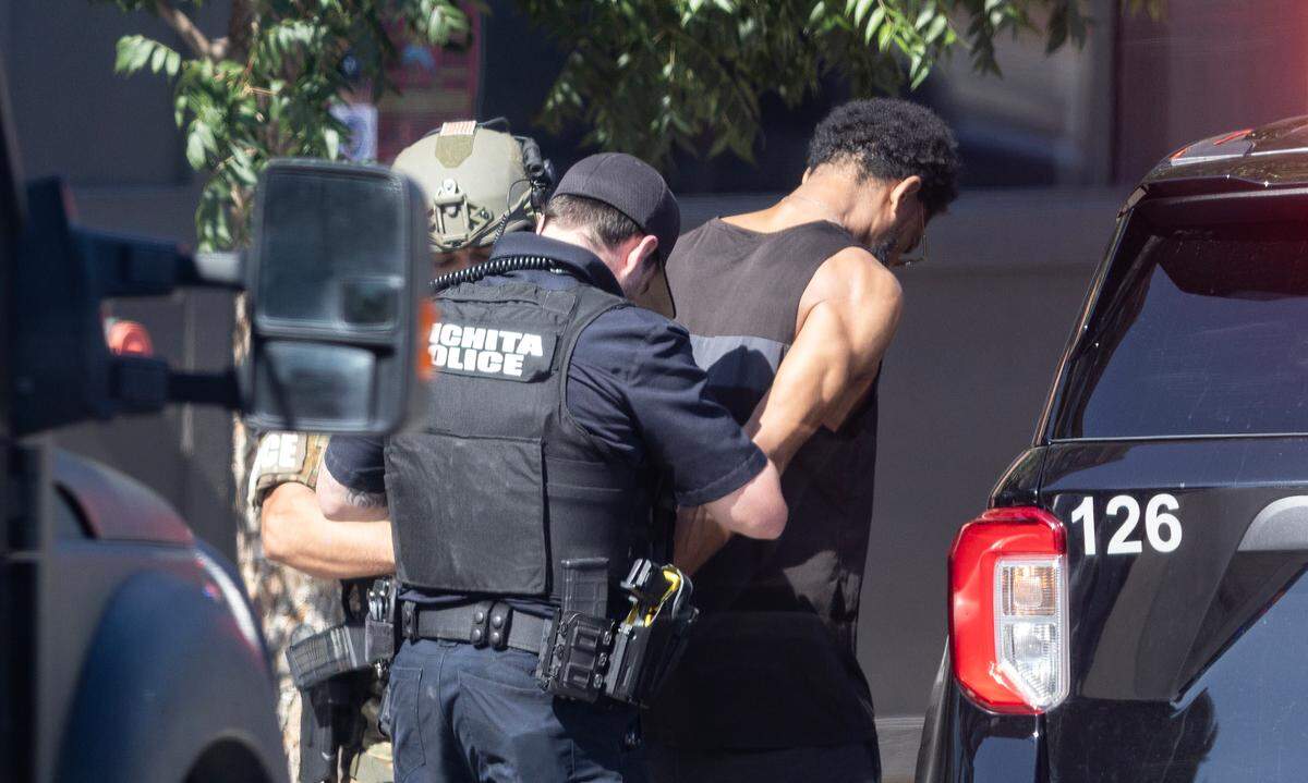 An unidentified man is placed under arrest in the 600 block of east Douglas on Wednesday after an hours long police standoff ended.